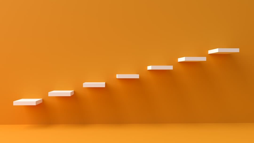 white steps rising on orange wall