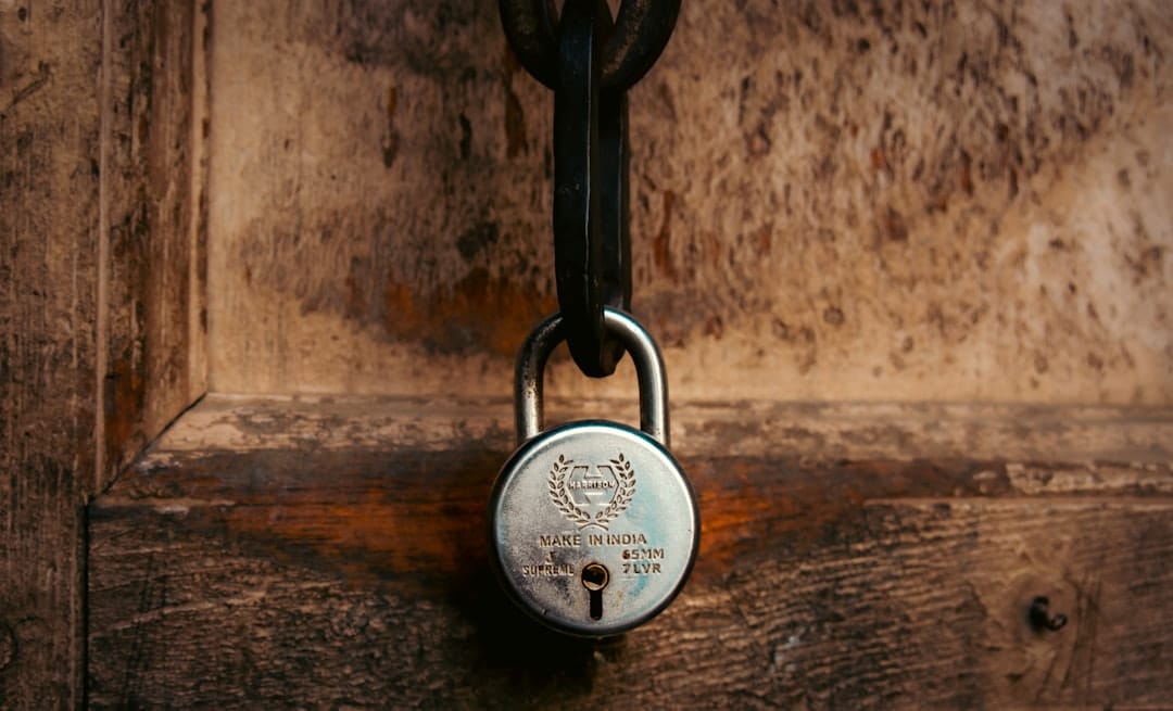 A padlock secures an old wooden door