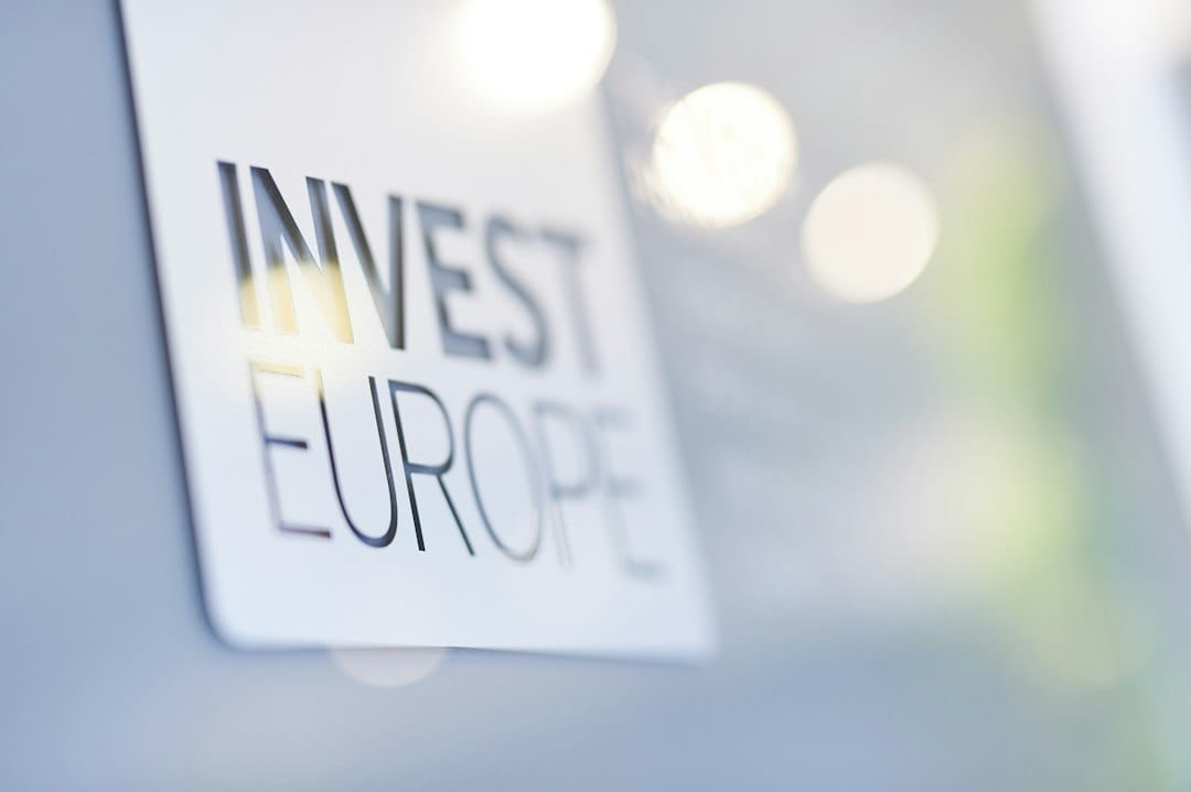 A sign displaying 'invest europe' with a blurred background